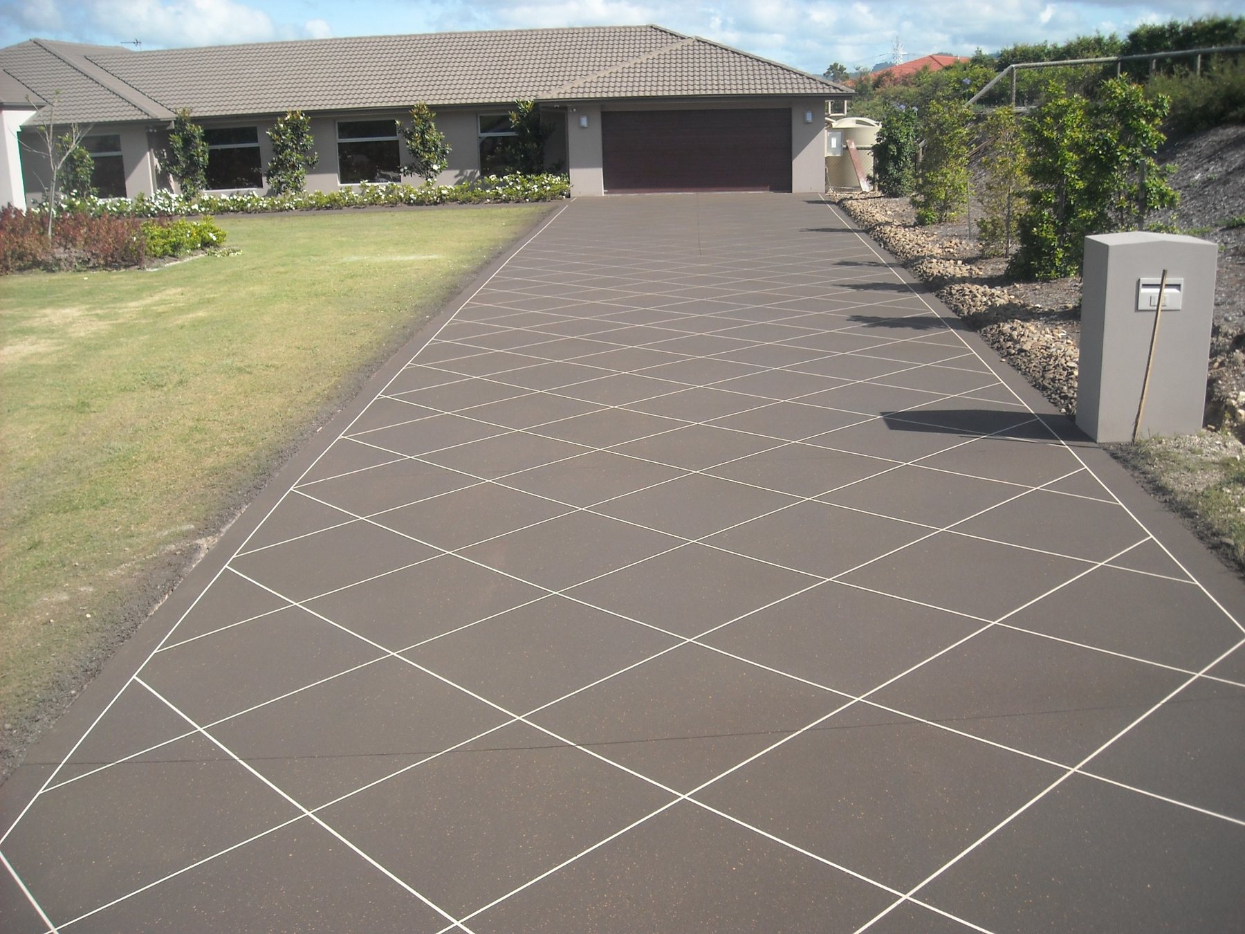 Brown decorative concrete coating with diagonal pattern on a Gold Coast driveway
