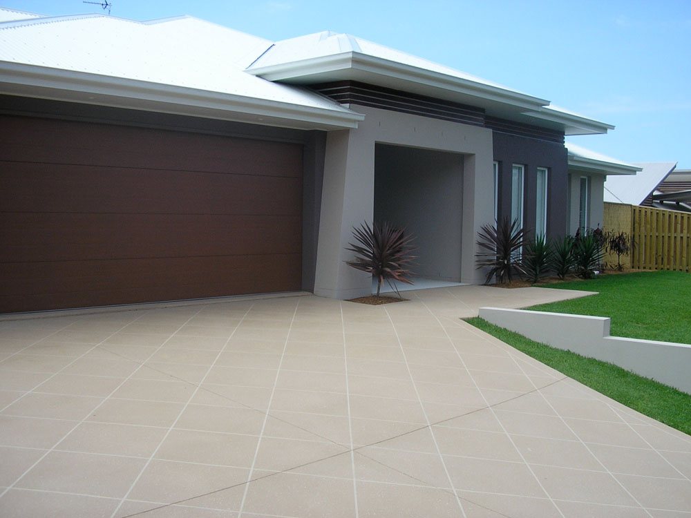 Clean decorative concrete driveway and path beside a modern Gold Coast home